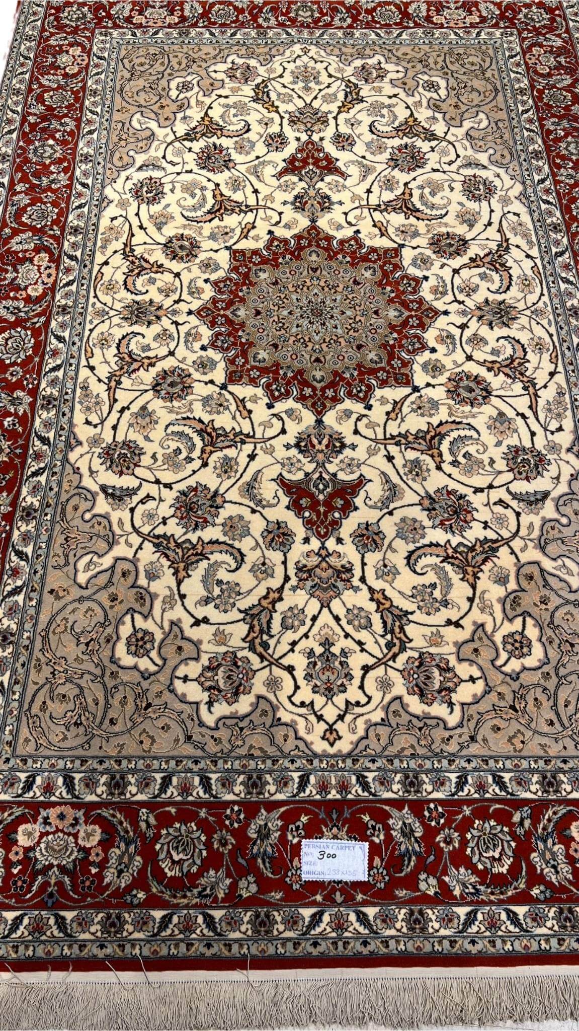 "Hand-knotted Persian Isfahan rug, crafted with silk and wool, featuring intricate traditional designs. Measuring 235 cm x 155 cm (7.7 ft x 5.1 ft) with a knot density of 810,000 knots per square meter. This luxurious handmade Persian rug adds timeless elegance to any space. Available for purchase online, with only one piece in stock."